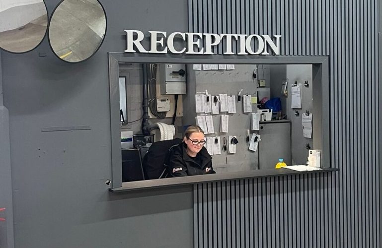 Woman sitting at Dalziels garage reception
